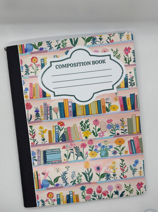 Decorative composition book with floral and book design on a white surface